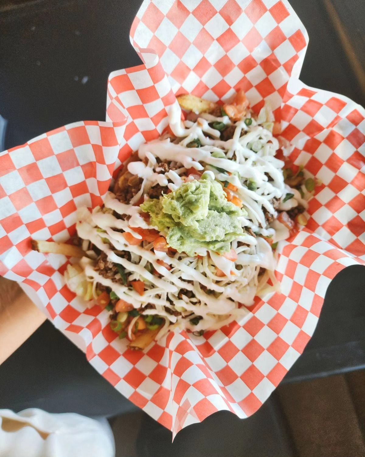 Loaded fries topped with a fried egg and green onion